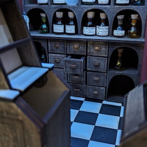 May include: A wooden apothecary cabinet with multiple drawers and shelves. The shelves are filled with small glass bottles with labels. The cabinet is in a room with a black and white checkered floor.
