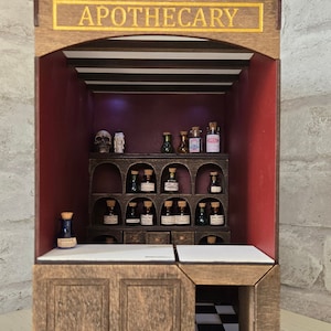 May include: A miniature wooden apothecary shop with a sign that reads "APOTHECARY" in gold lettering. The shop has a counter, shelves, and a small back room with a checkered floor. There are many small glass bottles filled with colorful liquids on the shelves.