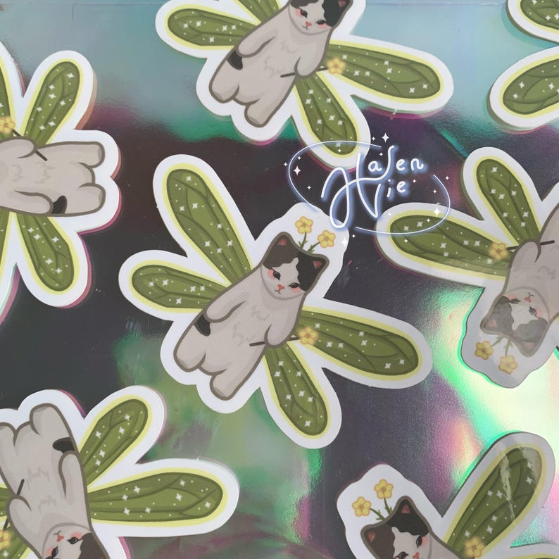 fairy cat with green wings and a black and white body color
