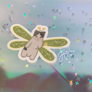 fairy cat with green wings and a black and white body color