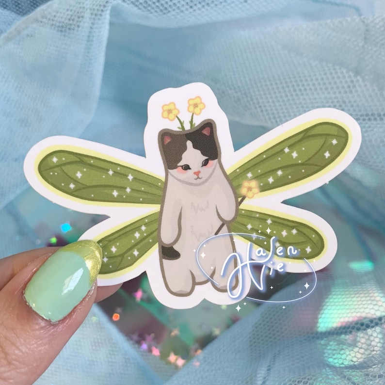 fairy cat with green wings and a black and white body color