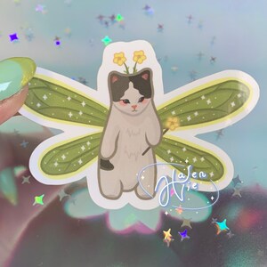 fairy cat with green wings and a black and white body color