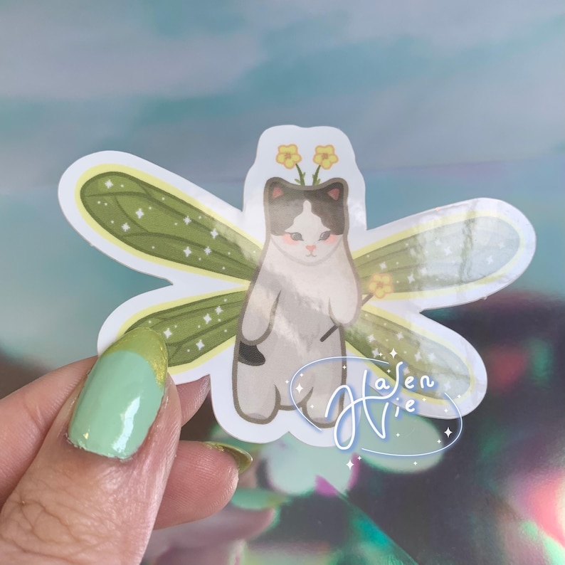 fairy cat with green wings and a black and white body color
