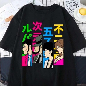 May include: Black t-shirt with a graphic print of four cartoon characters and Japanese text that reads "九龙五不".