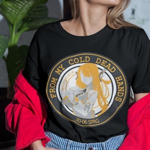 May include: Black t-shirt with a circular graphic featuring a woman holding a sword and the text "From My Cold Dead Hands" with the date "30-06 SPRG" and the word "Springfield" in a circle.