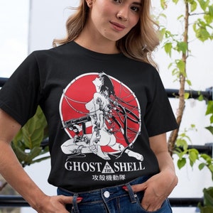 May include: A black t-shirt with a red circle graphic featuring a woman with wires and a gun. The text "Ghost in the Shell" and "攻殻機動隊" are printed below the graphic.