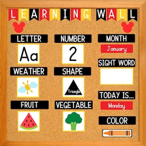 May include: A corkboard learning wall with colorful flags and Mickey Mouse ears at the top. The board is divided into sections with headings like "Letter", "Number", "Month", "Weather", "Shape", "Sight Word", "Fruit", "Vegetable", "Today Is...", "Color". Each section has a corresponding image or word. For example, the "Letter" section shows the letter "Aa", the "Number" section shows the number "2", and the "Month" section shows the word "January".