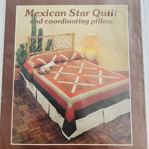 May include: A bed with a Mexican Star Quilt and coordinating pillow. The quilt features a red and brown geometric design with white accents. The bed has a bamboo headboard and a white bed skirt. The text "Mexican Star Quilt and coordinating pillow" is at the top.