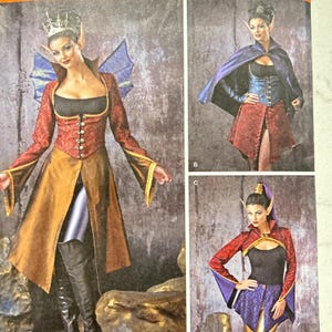 May include: A costume pattern featuring three fantasy-themed outfits. The main image showcases a woman in a red and gold gown with a crown and elf ears. Other images show variations of the costume with capes and different color schemes.