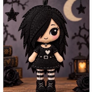 May include: A felt doll with long black hair, large black eyes, and pink cheeks. The doll wears a black dress with a white heart, a black choker with a heart charm, a belt, and black and white striped leggings with black boots.
