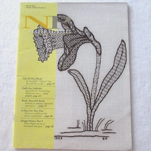 May include: A magazine cover featuring a daffodil embroidery design. The left side is yellow with text, including "March 2005" and "Needle Pointers." The right side shows a detailed brown and white embroidered daffodil.