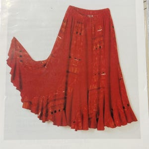 May include: A flowing, red skirt with a ruffled hem. The skirt has a high waist and a flared silhouette. The fabric has a textured appearance with a pattern of rectangles and lines. The skirt is made of a lightweight material.