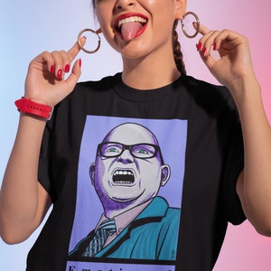 May include: Black t-shirt with a graphic print of a cartoon man with a surprised expression. The text "Emotional Vampire" is printed below the image.