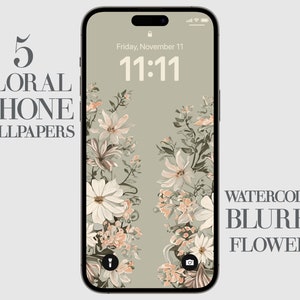 May include: A digital phone screen with a floral wallpaper design. The wallpaper features a watercolour style with blurry flowers in shades of pink, white, and green. The phone screen displays the time 11:11 and the date Friday, November 11. The text "WATERCOLOR BLURRY FLOWERS" is displayed at the bottom of the screen.