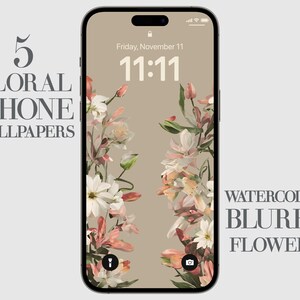 May include: A floral iPhone wallpaper with a watercolour effect. The wallpaper features a light brown background with pink, white, and yellow flowers. The time is 11:11 on the phone screen. The text "WATERCOLOR BLURRY FLOWERS" is displayed on the right side of the image.