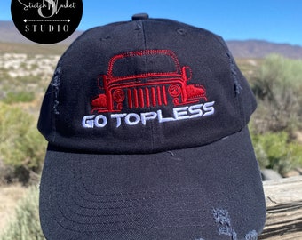 May include: A black distressed baseball cap with a red embroidered Jeep silhouette and the text "GO TOPLESS" in white.