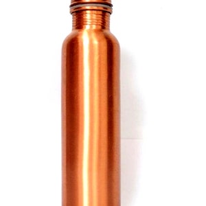 May include: A copper water bottle with a screw-on lid. The bottle is a shiny, metallic copper color.