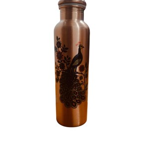 May include: A cylindrical copper water bottle featuring a dark brown printed graphic of a peacock perched on a flowering branch. The bottle has a smooth metallic finish, a narrow neck, and a matching copper cap with a visible white seal ring.