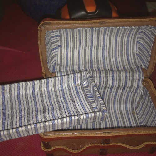 Doll toy trunk. Miniaturization of a large trunk, all upholstered in