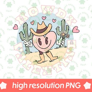 以下が含まれることがあります： カウボーイハットとブーツを履いた、笑顔のハート型のキャラクターの気まぐれなイラスト。デザインにはサボテン、ハート、レトロなフォントの「Howdy Valentine」の文字が、水色の背景に描かれています。