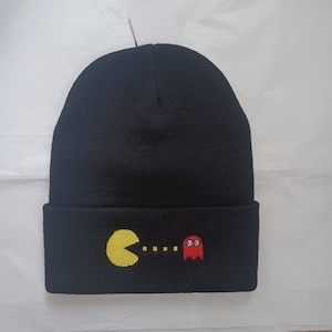 May include: Black beanie with a Pac-Man and ghost graphic embroidered on the front.