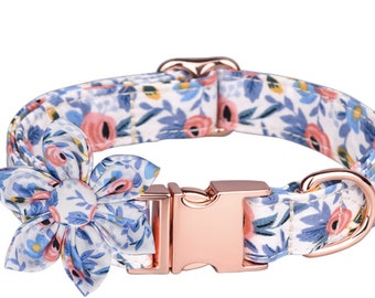 May include: A white dog collar with a floral pattern and a rose gold buckle. The collar has a matching floral bow.