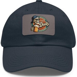 May include: A navy blue baseball cap with an embroidered patch featuring a cartoon skeleton holding a beer and the text "Official Cool Dads Club Member".