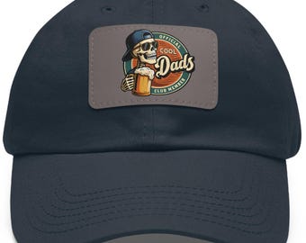 May include: A navy blue baseball cap with an embroidered patch featuring a cartoon skeleton holding a beer and the text "Official Cool Dads Club Member".