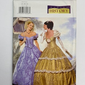 May include: Butterick P412 sewing pattern for historical dresses. The cover features illustrations of two women in period gowns. One dress is lavender with a floral pattern, and the other is gold with lace trim. The pattern includes sizes 18-20-22.
