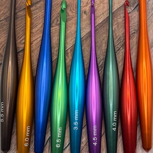 May include: A set of ten colourful crochet hooks, ranging in size from 3.5 mm to 6.0 mm. The hooks are made of metal and have a smooth, polished finish.