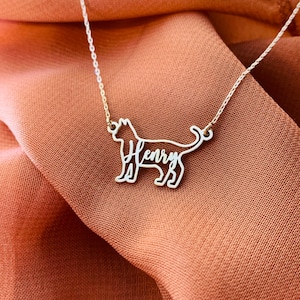 May include: A silver necklace with a cat-shaped pendant. The cat's outline is formed by the name "Henry" in cursive.