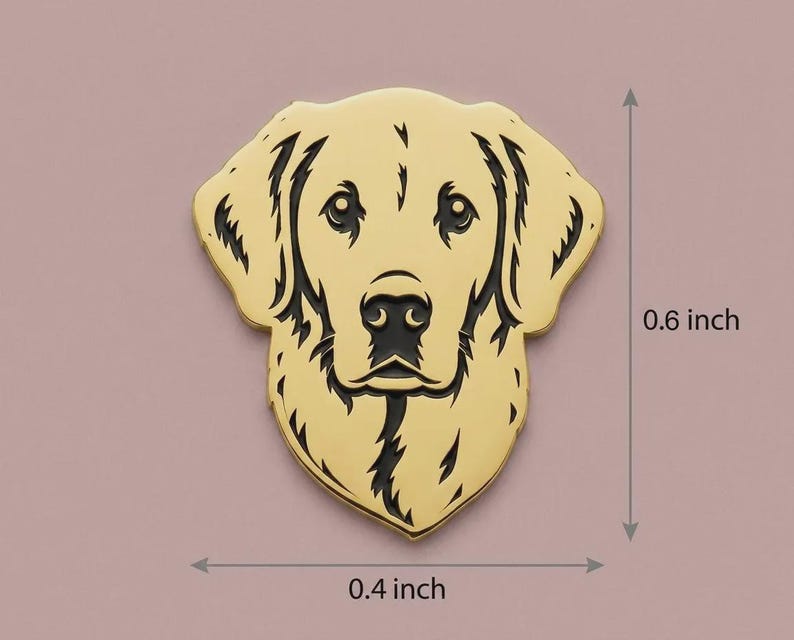 May include: A golden-colored metal pin in the shape of a Golden Retriever's head. The pin is 0.6 inches tall and 0.4 inches wide. The dog's features are detailed with black lines, including the eyes, nose, and mouth.