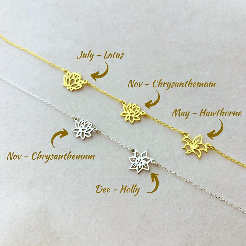 May include: Four silver chains with delicate flower charms, each charm representing a different month: July - Lotus, November - Chrysanthemum, May - Hawthorn, and December - Holly.