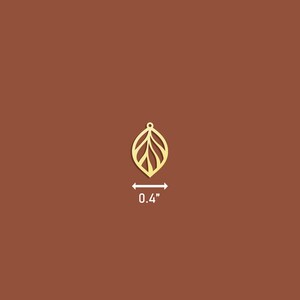 May include: Gold leaf charm with a delicate, intricate design. The charm is 0.4 inches in size.