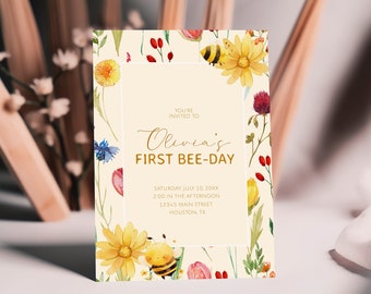 May include: A yellow and white floral invitation with a bee and the text "You're invited to Olivia's First Bee-Day" with the date, time, and location of the event.