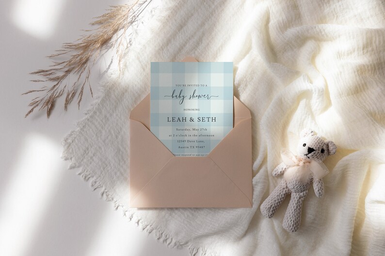 May include: A light blue and white gingham baby shower invitation with the text "You're invited to a baby shower" and "honoring Leah & Seth" in a script font. The invitation includes the date, time, and location of the event.