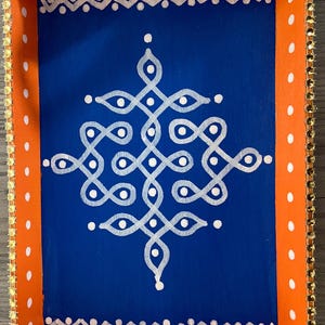 May include: A wooden serving tray with a blue interior and orange exterior. The tray has a white geometric design painted on the blue surface and a white polka dot pattern on the orange surface. The tray has a gold trim around the edges.