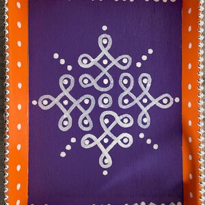 May include: A wooden serving tray with an orange border and white polka dots. The tray has a purple interior with a white geometric design.