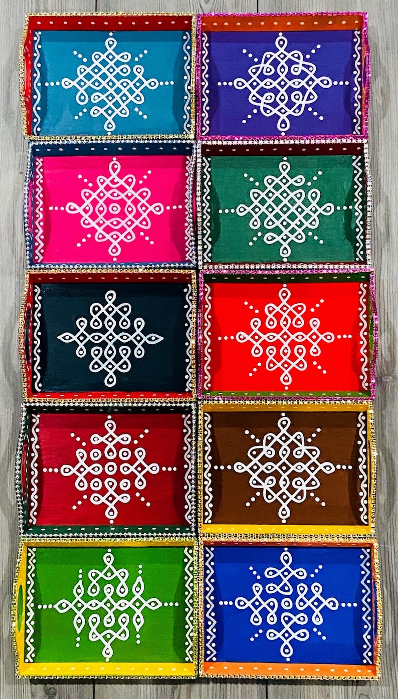 May include: Eight decorative wooden trays with colorful backgrounds and white geometric designs. The trays are arranged in two rows of four. The trays are all different colors, including red, blue, green, brown, and pink.