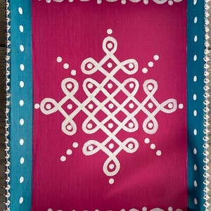 May include: A teal and pink wooden serving tray with white polka dots and a white geometric design in the center. The tray has silver beaded trim around the edges.