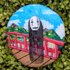 No Face inspired painted river rock