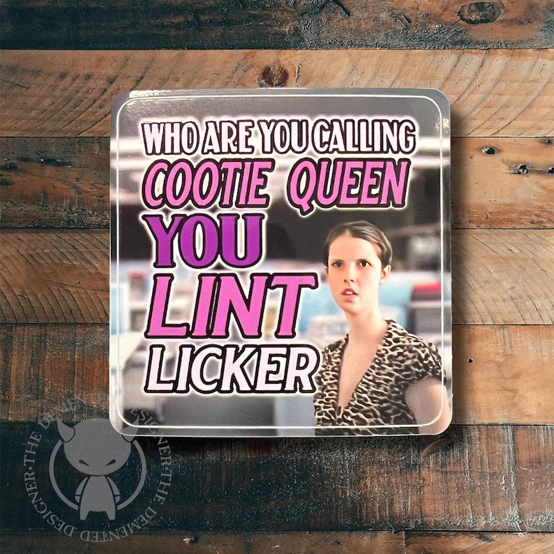 May include: A pink and purple square sticker with the text "Who are you calling cootie queen you lint licker" and a woman with brown hair wearing a leopard print shirt.
