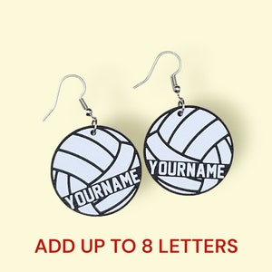 May include: A pair of silver volleyball earrings with a white volleyball design and the text "YOURNAME" in black. Add up to 8 letters.