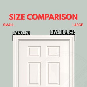 Black wood L-shaped door-corner signs reading “LOVE YOU, BYE” in bold letters. The Small version measures 10-3/4" wide × 6" tall, and the Large version measures 17-1/4" wide × 7-3/8" tall. Both are 1/4" thick and designed to perch on a door-frame corner without installation hardware.