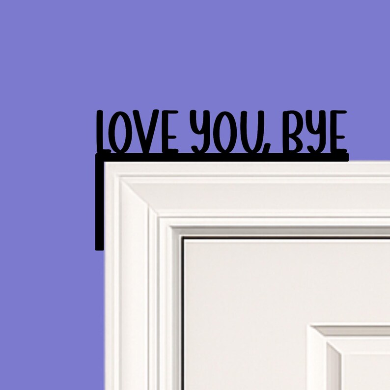 Black wood L-shaped door-corner signs reading “LOVE YOU, BYE” in bold letters. The Small version measures 10-3/4" wide × 6" tall, and the Large version measures 17-1/4" wide × 7-3/8" tall. Both are 1/4" thick and designed to perch on a door-frame corner without installation hardware.