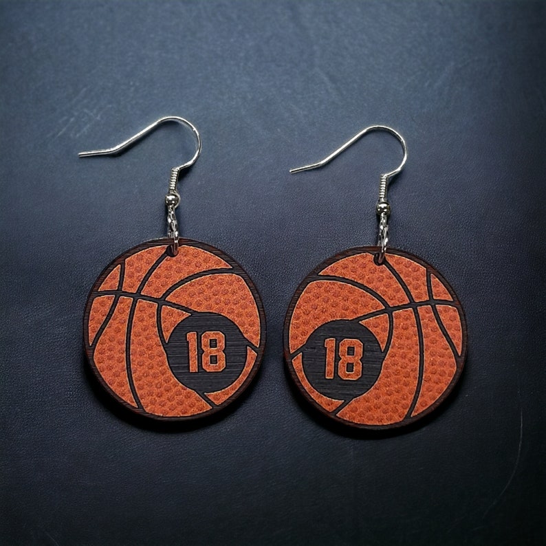 Personalized basketball earrings with a players jersey number. Made from lightweight acrylic, they measure 1/8" thick and 1.15" round. Great gift idea for basketball moms!