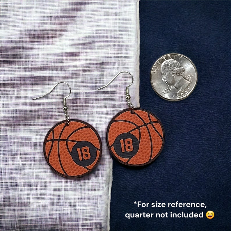 Personalized basketball earrings with a players jersey number. Made from lightweight acrylic, they measure 1/8" thick and 1.15" round. Great gift idea for basketball moms!