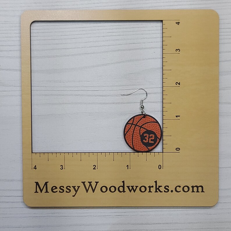 Personalized basketball earrings with a players jersey number. Made from lightweight acrylic, they measure 1/8" thick and 1.15" round. Great gift idea for basketball moms!