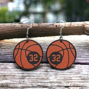Personalized basketball earrings with a players jersey number. Made from lightweight acrylic, they measure 1/8" thick and 1.15" round. Great gift idea for basketball moms!