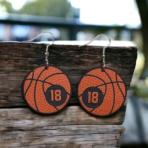 Personalized basketball earrings with a players jersey number. Made from lightweight acrylic, they measure 1/8" thick and 1.15" round. Great gift idea for basketball moms!